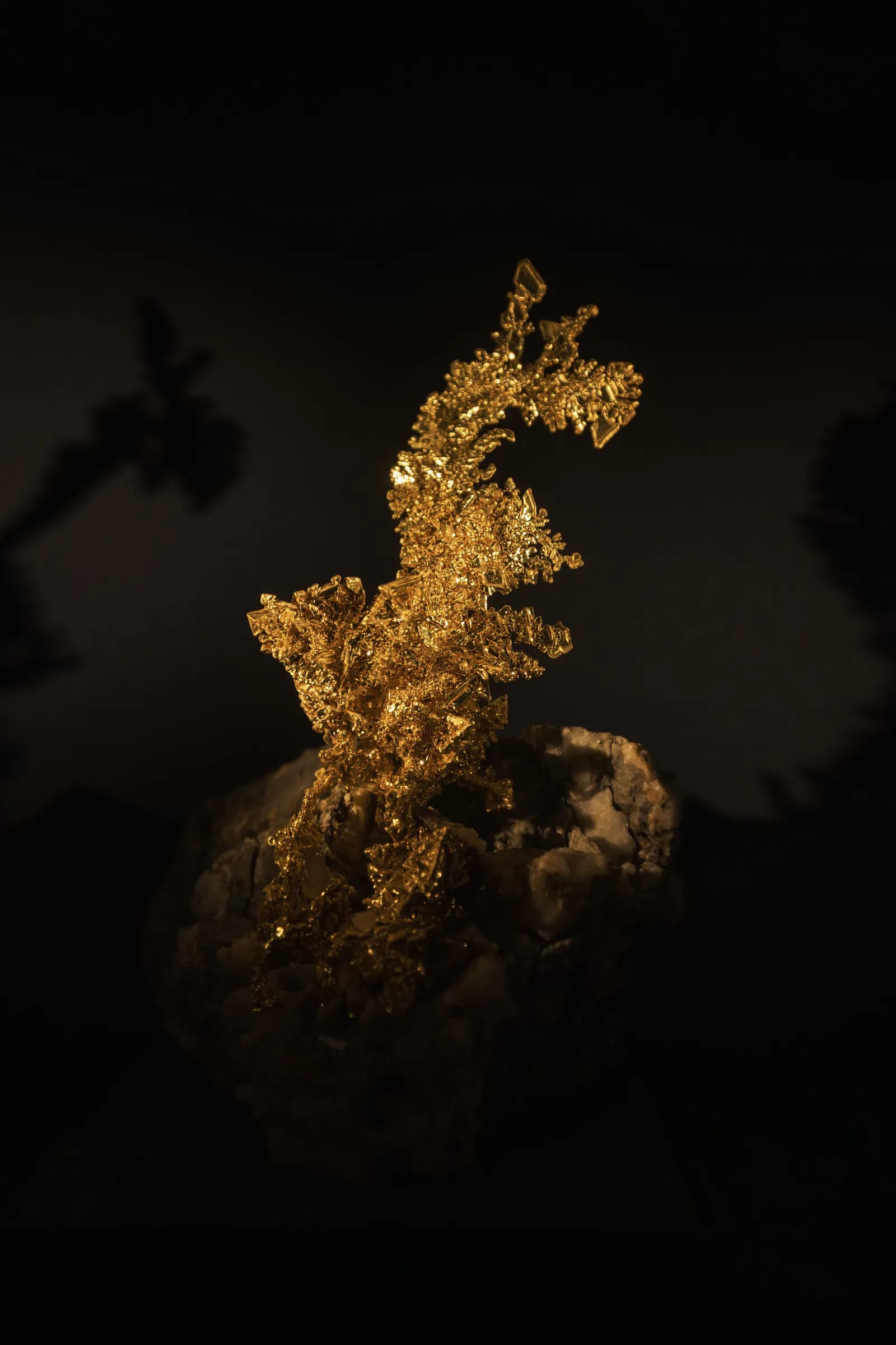 Raw crystalline gold against a dark background