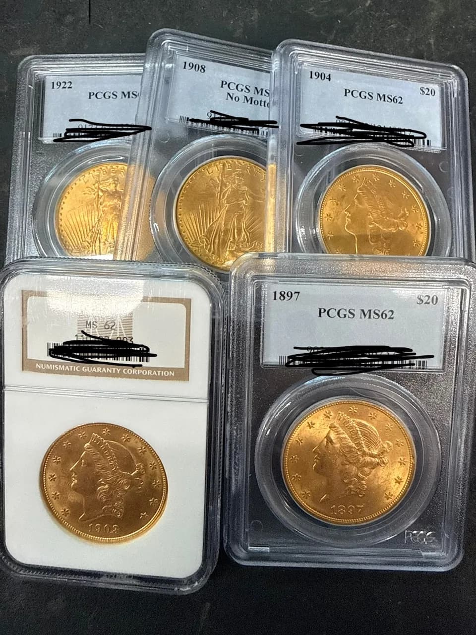 Five PCGS- and NGC-graded $20 gold Double Eagles in slabs, graded MS62