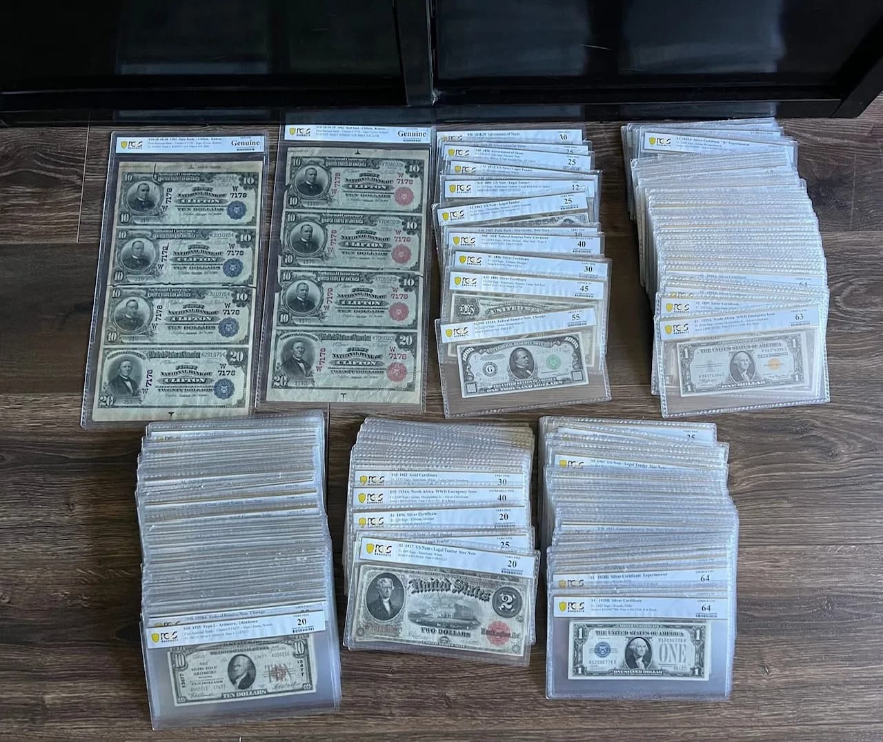 Stacks of PCGS-graded US currency: National Bank Notes, silver certificates, and legal tender notes