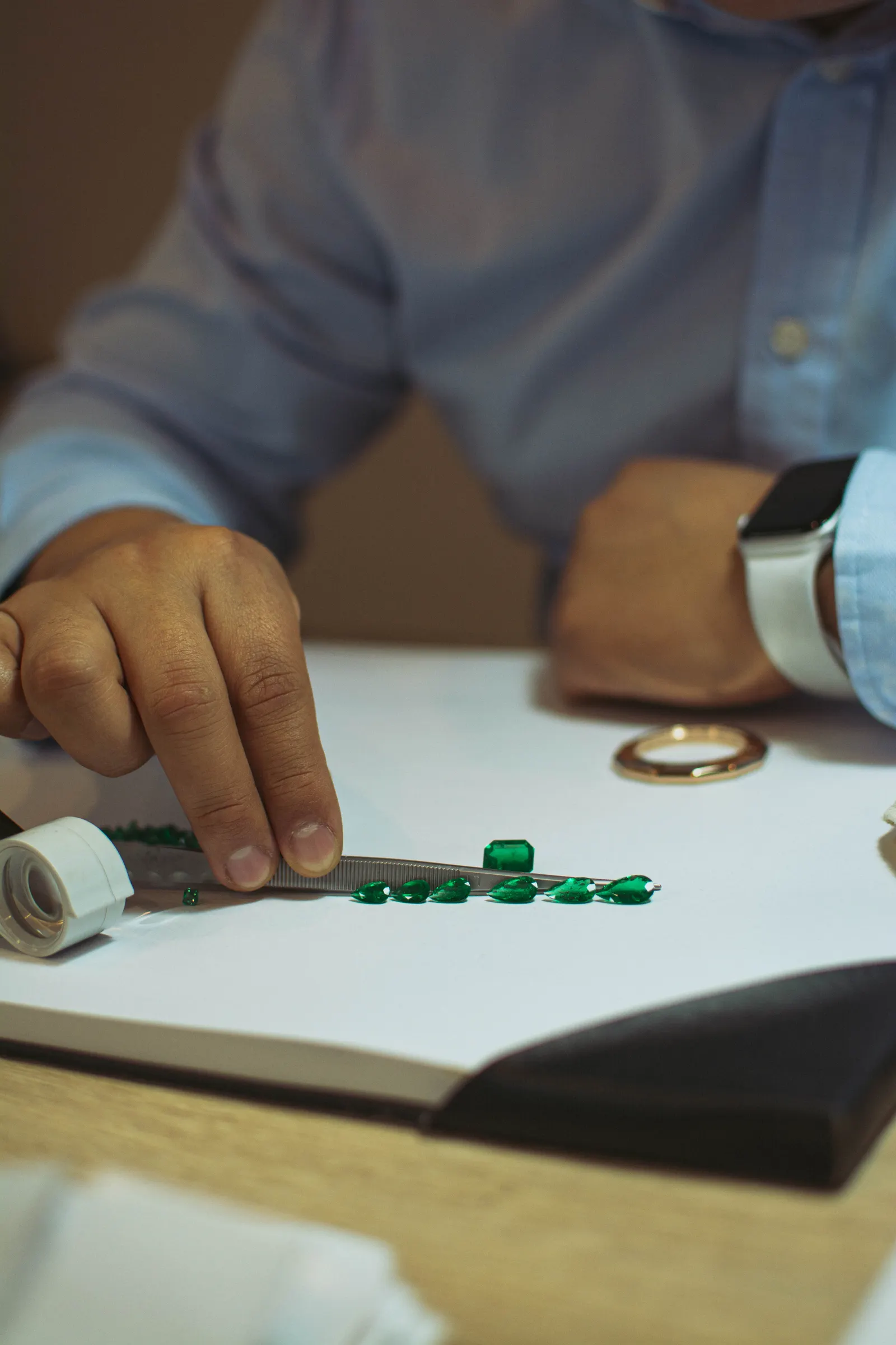 A jeweler examining stones at the workbench